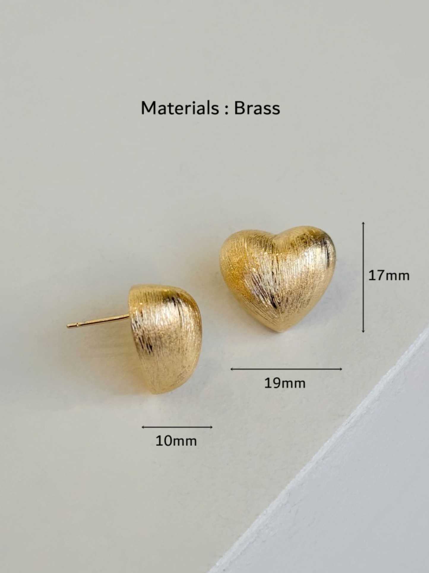 gold brushed-metal heart studs with size markings, showing 19mm width and 17mm height against a clean background.
