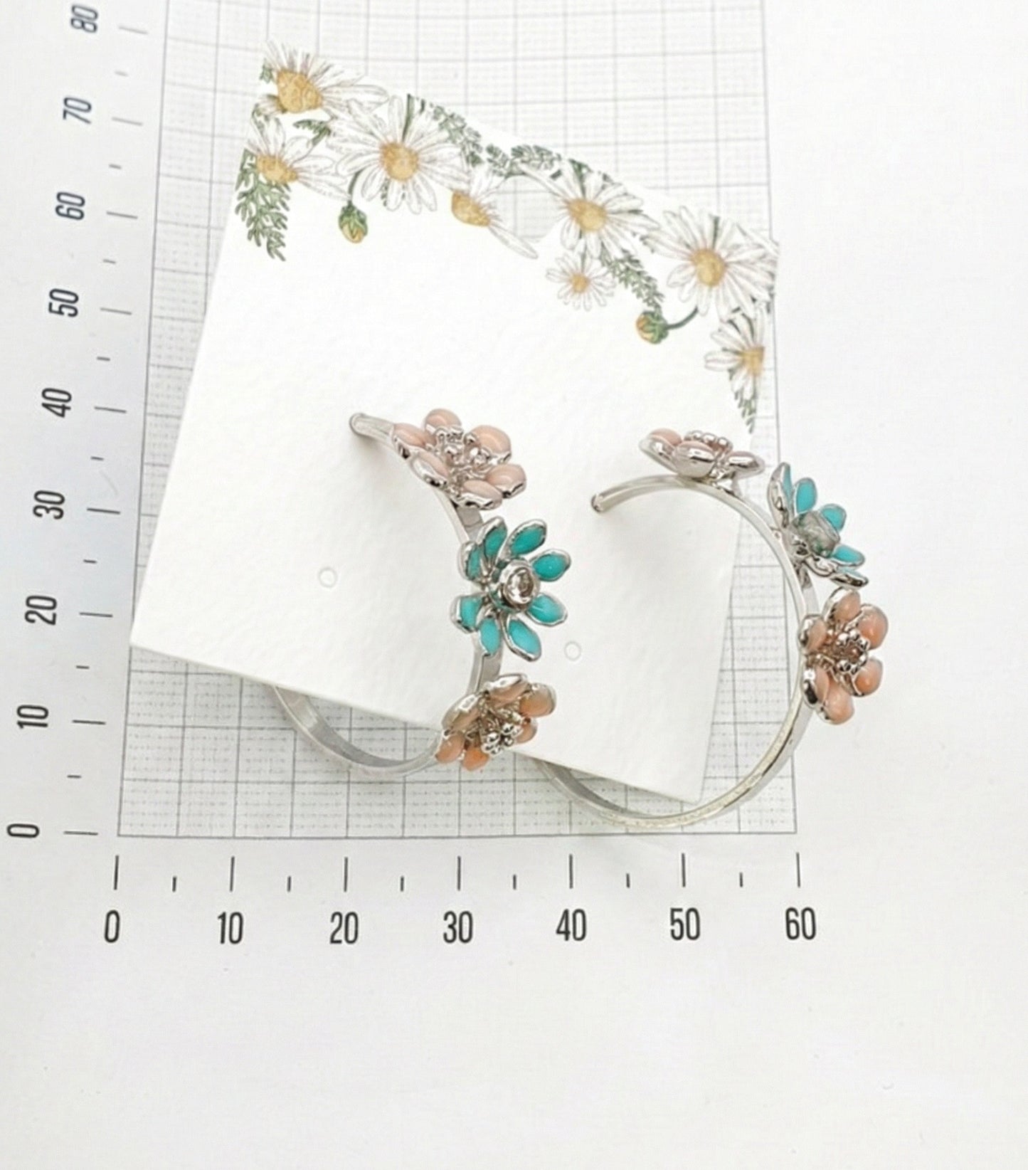 size reference of mint garden enamel flower hoop earrings with measuring ruler showing 2.5-3cm diameter