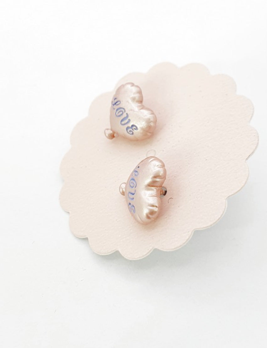 Back view of champagne beige heart balloon earrings showing titanium post