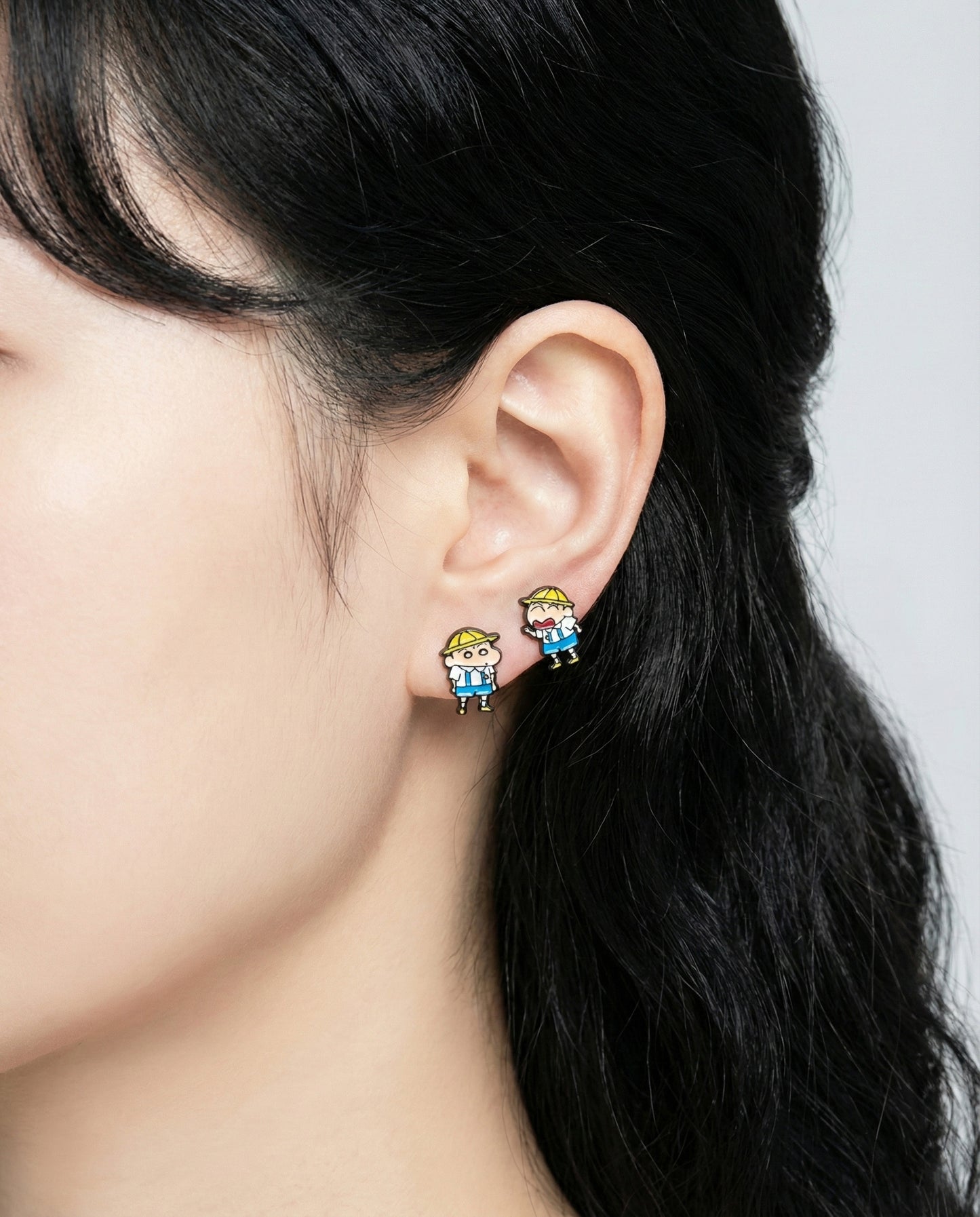 Rear angle of model showcasing Crayon Shin-chan friendship earrings in daily styling"