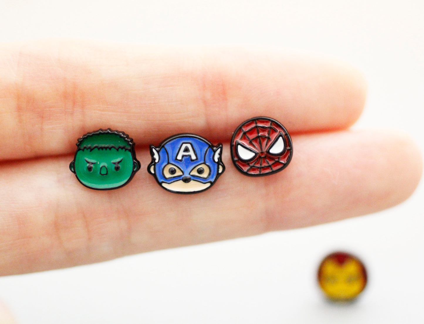 Marvel Avengers character earrings on palm showing Hulk Captain America Spider-Man with 925 silver posts handmade brass studs