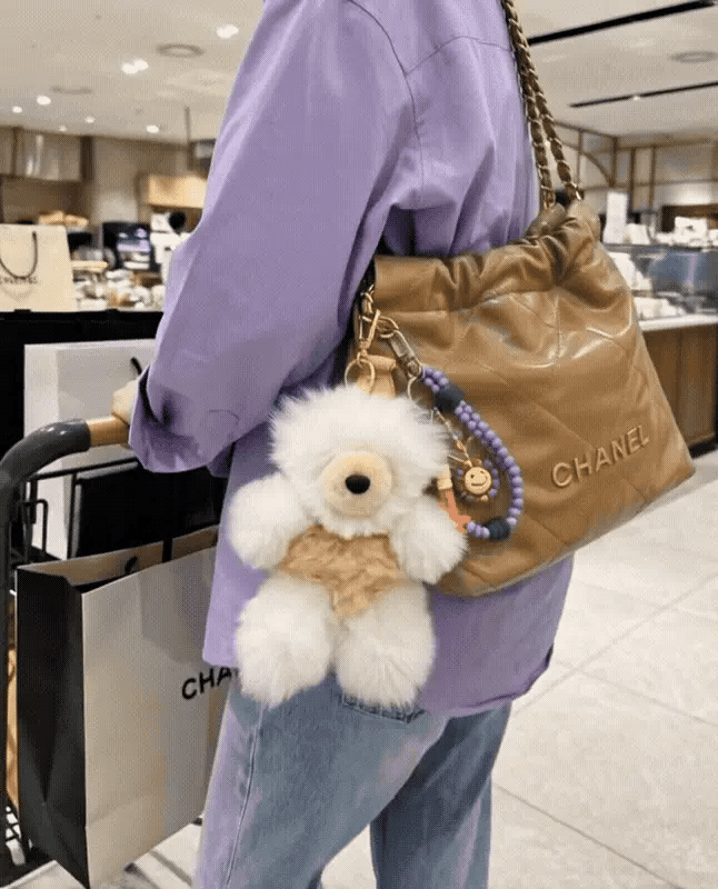 
Street modern bag charm stack inspo 8ttitto8 fluffy alpaca bear keychain with smile bead keychain on quilted designer bag, downtown girl K-style look.