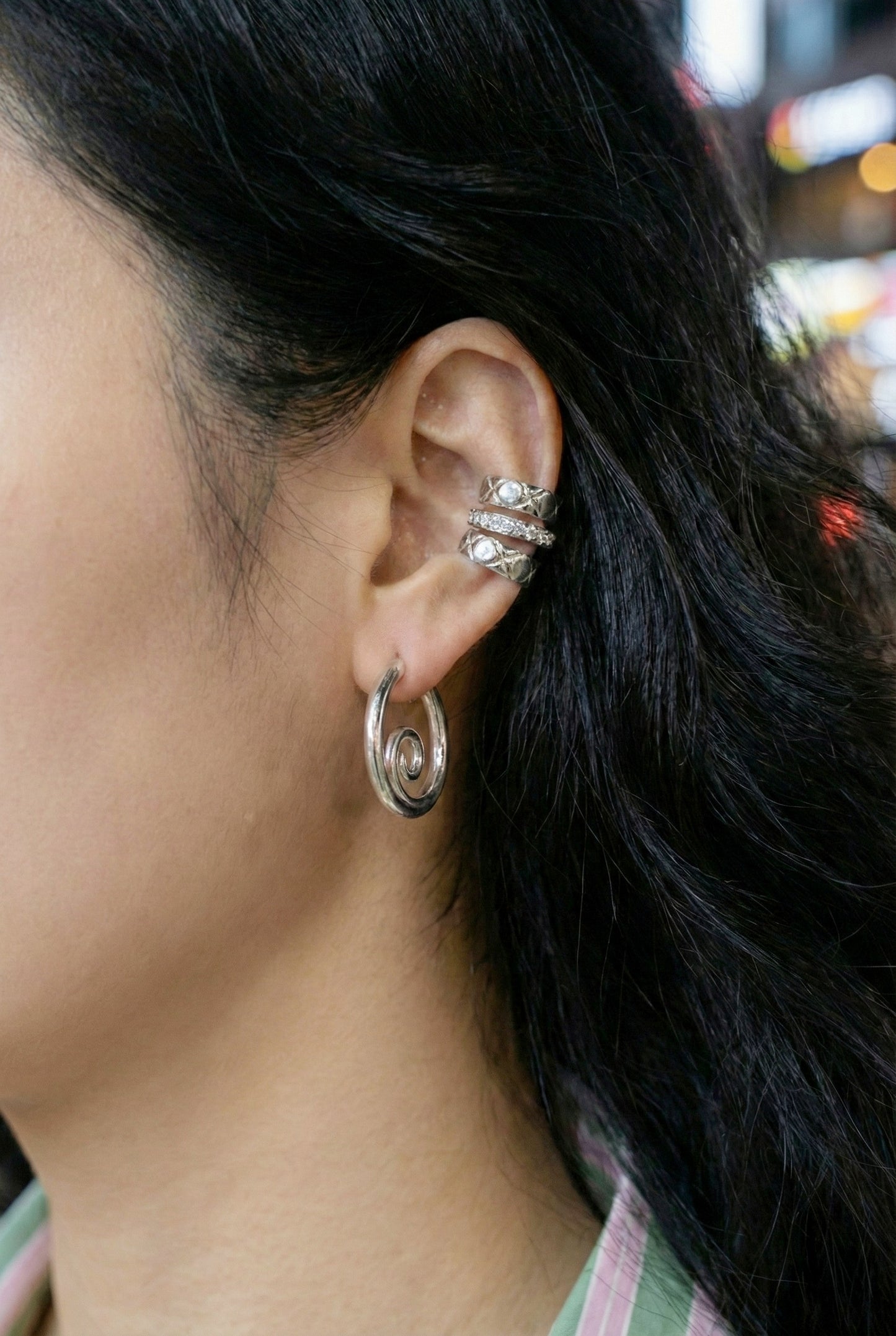 Silver spiral hoops layered with crystal ear cuffs - trendy ear stack styling