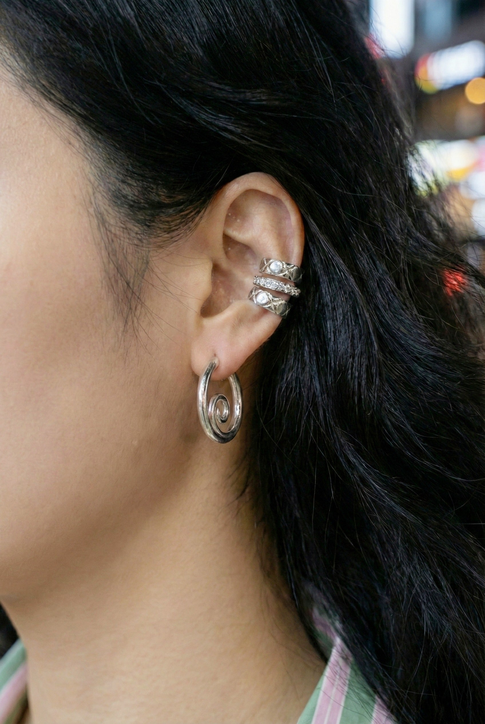Silver spiral hoops layered with crystal ear cuffs - trendy ear stack styling