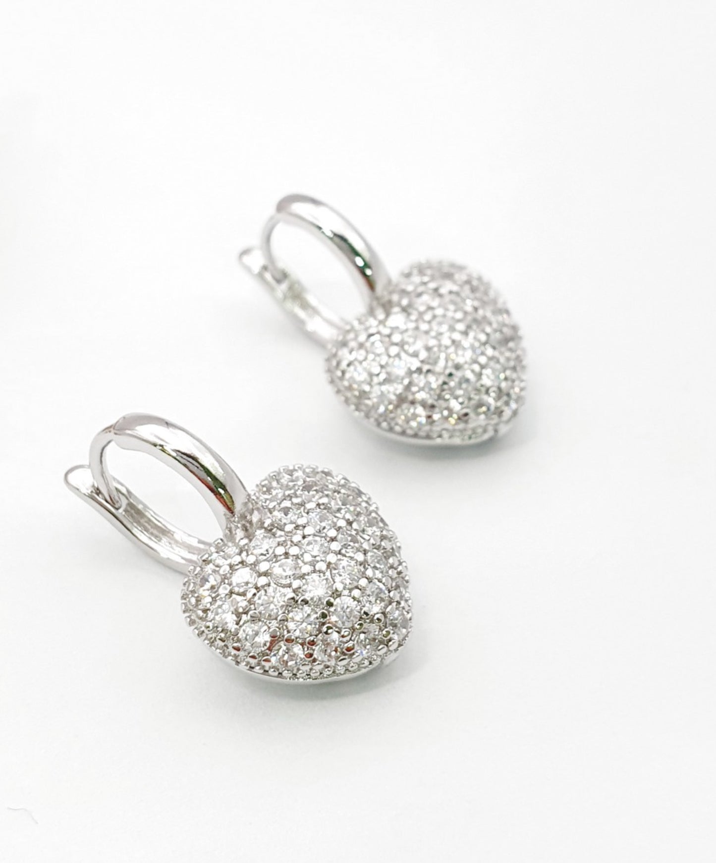 Close up of sterling silver pave CZ heart earrings showing micro pave stone setting