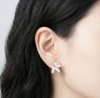Model wearing pearl white balloon dog earring showing elegant minimalist look