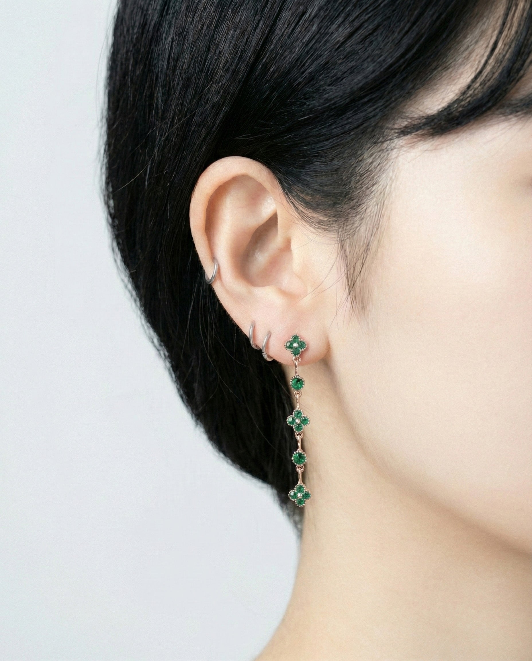 Emerald green vintage inspired clover drop earrings on model