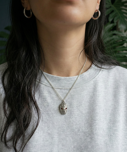 Woman wearing a unique 925 silver spider pendant with a casual grey sweatshirt