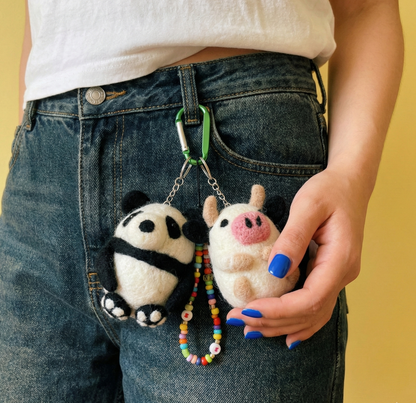 Panda and cow wool felt keychains attached to denim jeans belt loop with colorful beaded keychain Y2K styling"