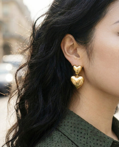 Gold heart earrings styled with polka dot shirt - romantic daytime look