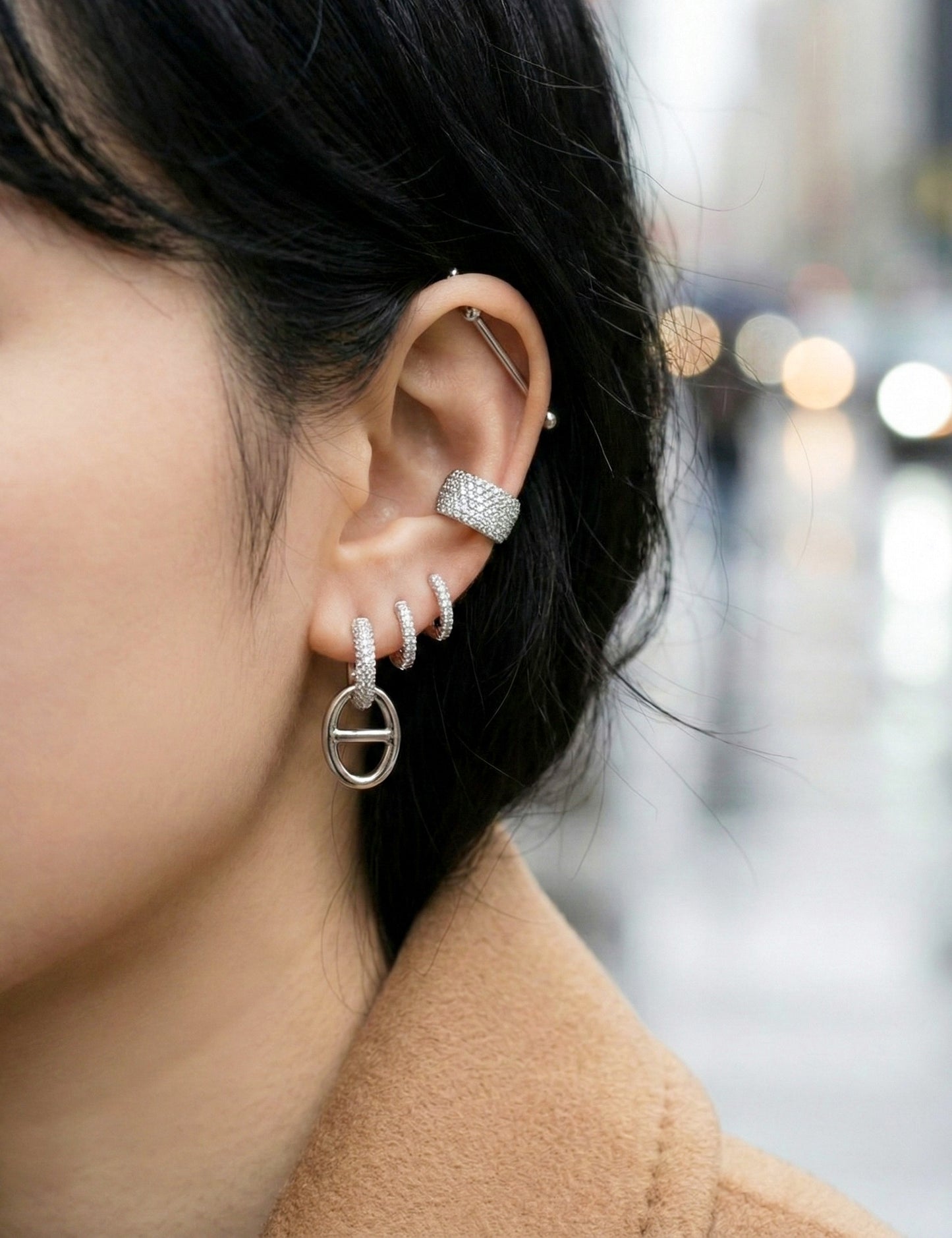 Ear stack featuring pavé huggie earrings layered with other jewelry