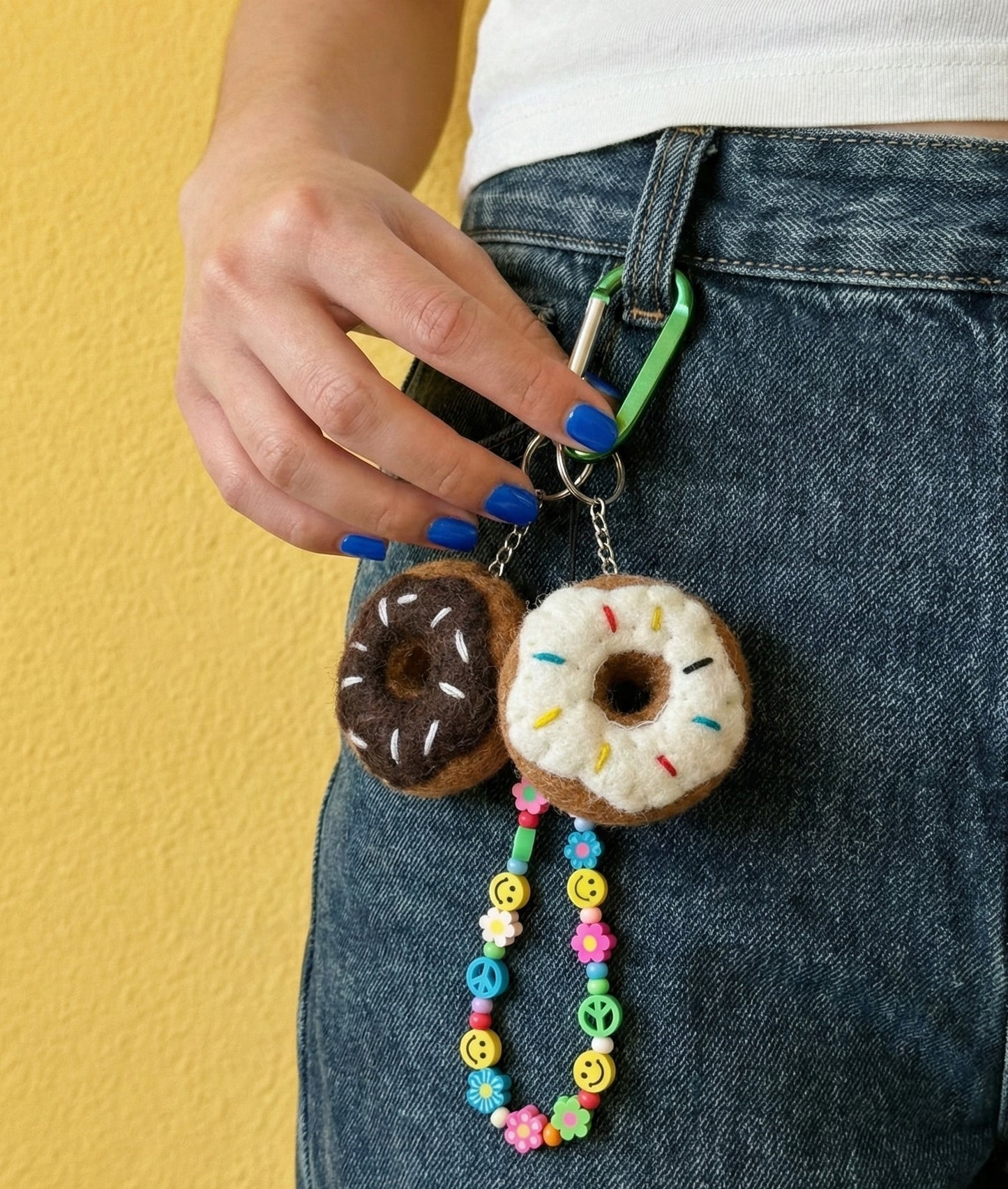 Donut wool felt keychains on denim jeans belt loop with colorful beaded chain, Y2K aesthetic styling