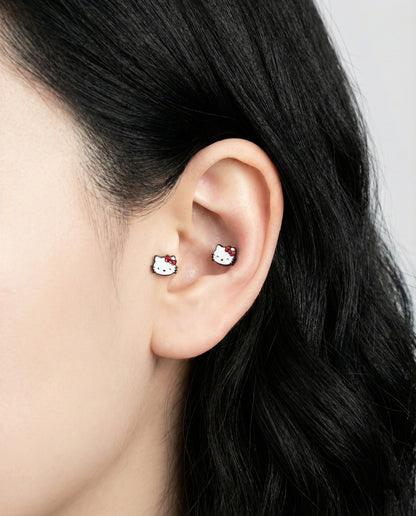 Hello Kitty barbell studs worn in inner conch and lobe piercing ear stack