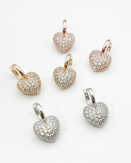 Three pairs of sparkly heart drop huggie earrings showing front view pave setting detail