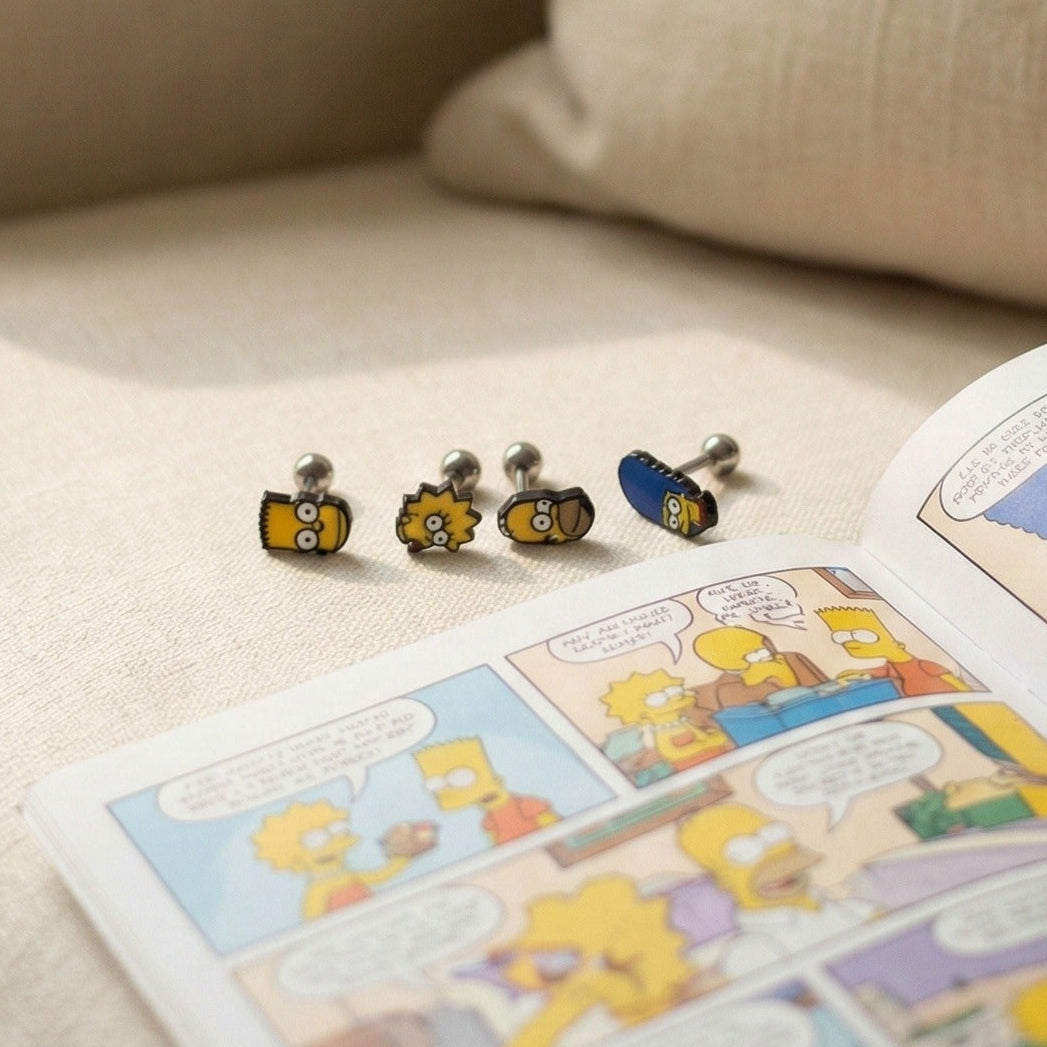 Full Simpsons family piercing set worn on ear - Marge in helix, Bart in conch, Lisa in lobe, complete ear curation
