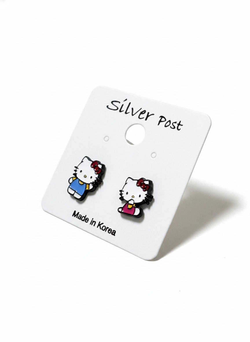 
Hello Kitty asymmetrical earrings packaging on clear stand with Hello Kitty wallpaper backdrop