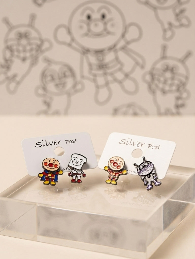 Two sets of Anpanman earrings displayed on clear stand