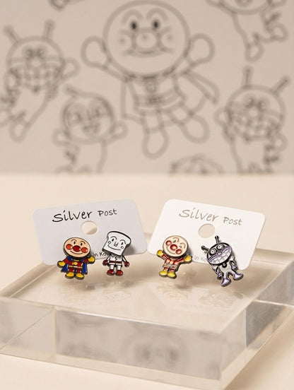Two sets of Anpanman earrings displayed on clear stand
