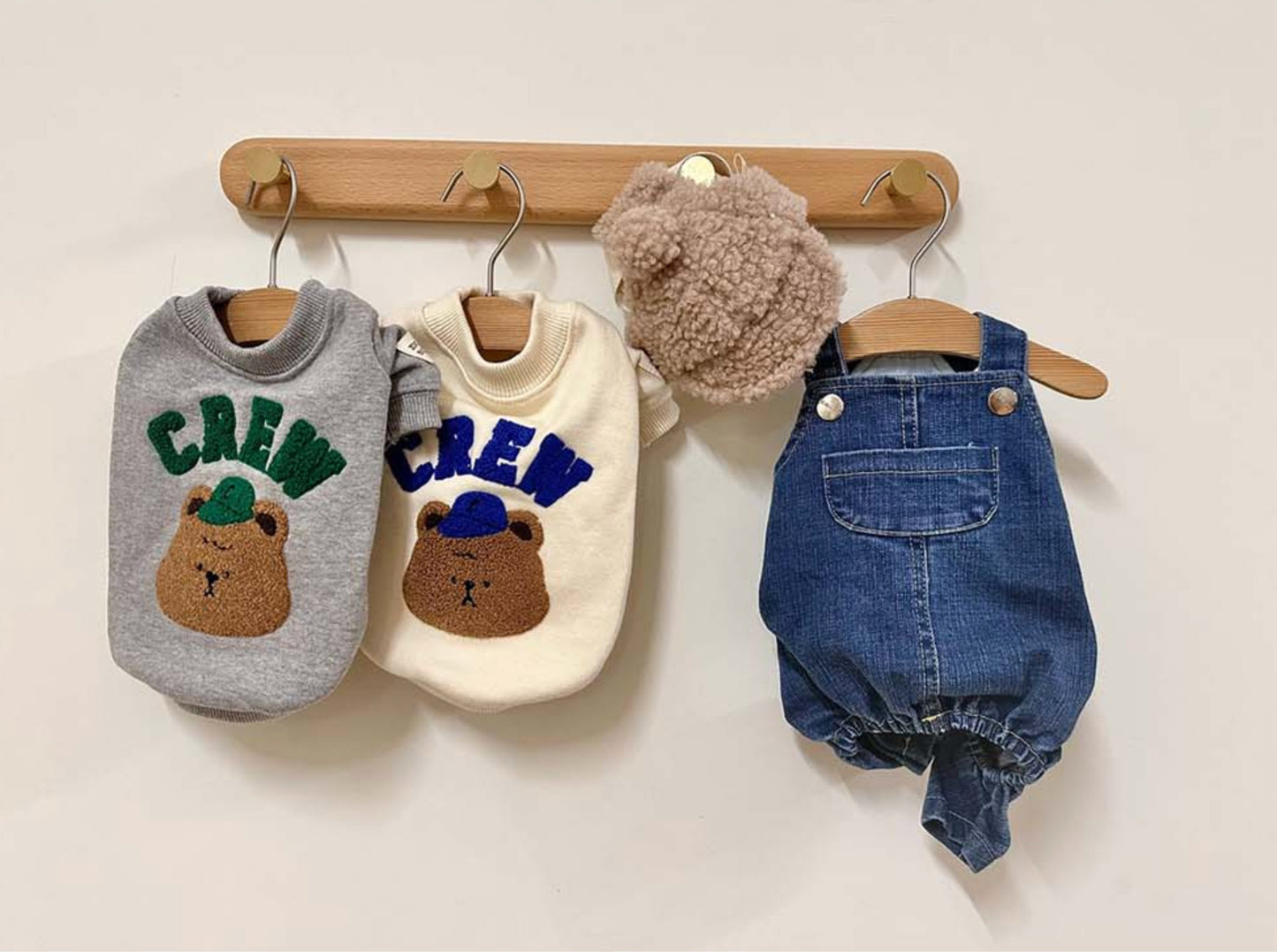 Dog clothing displayed on hangers showing cream and grey options