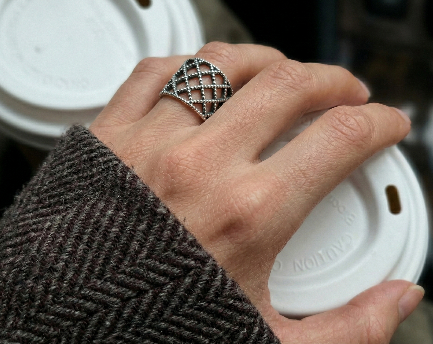 Lace lattice 925 sterling silver bold ring worn while holding coffee cup, herringbone wool coat sleeve, everyday styling, chunky silver ring detail