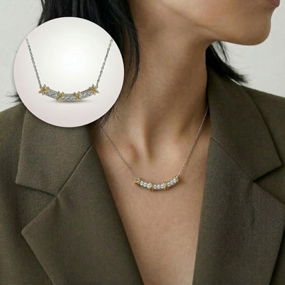 Necklace with a close-up inset on a person wearing a brown blazer.