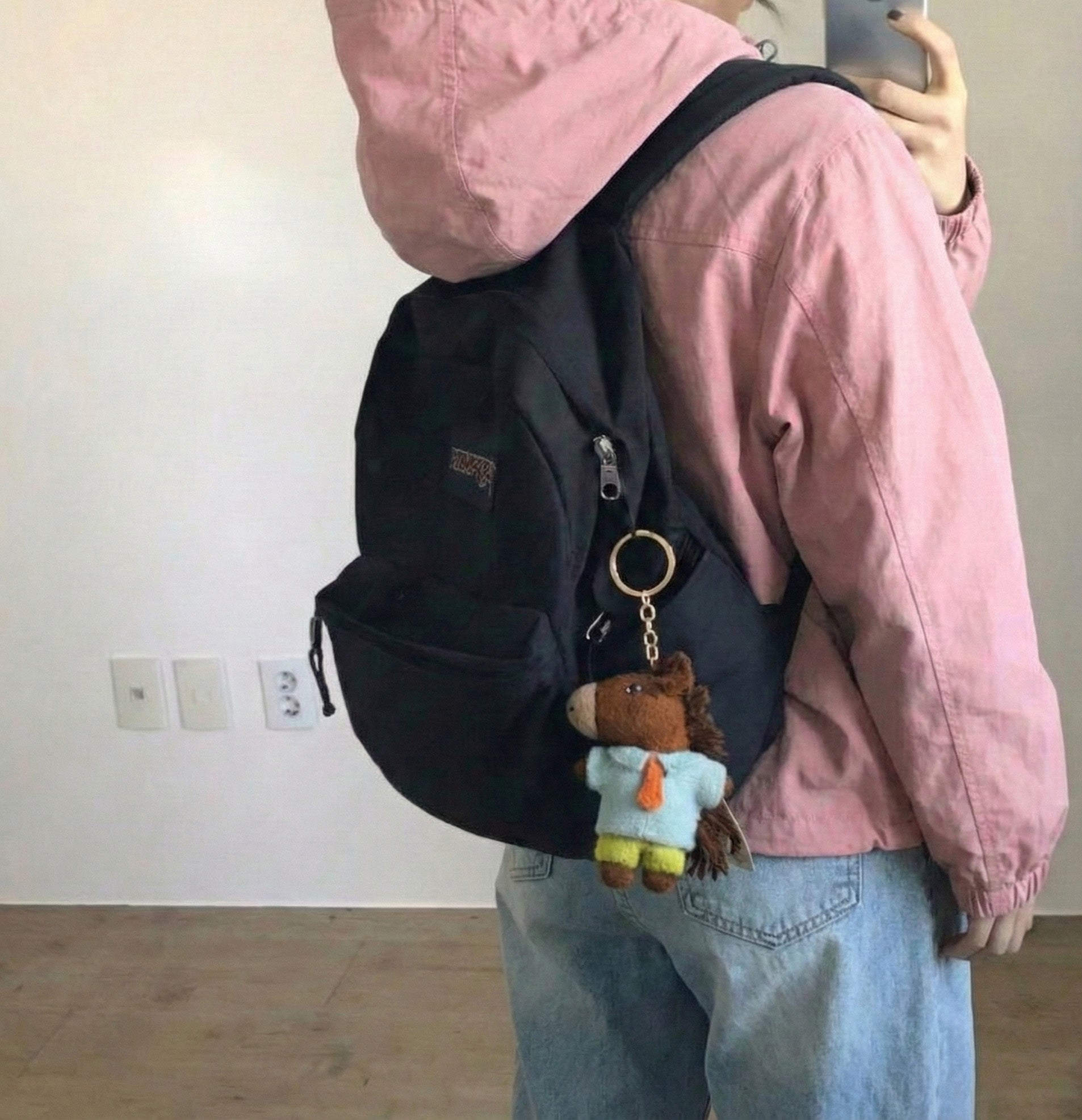 Horse lover keychain attached to white Jansport backpack for college student