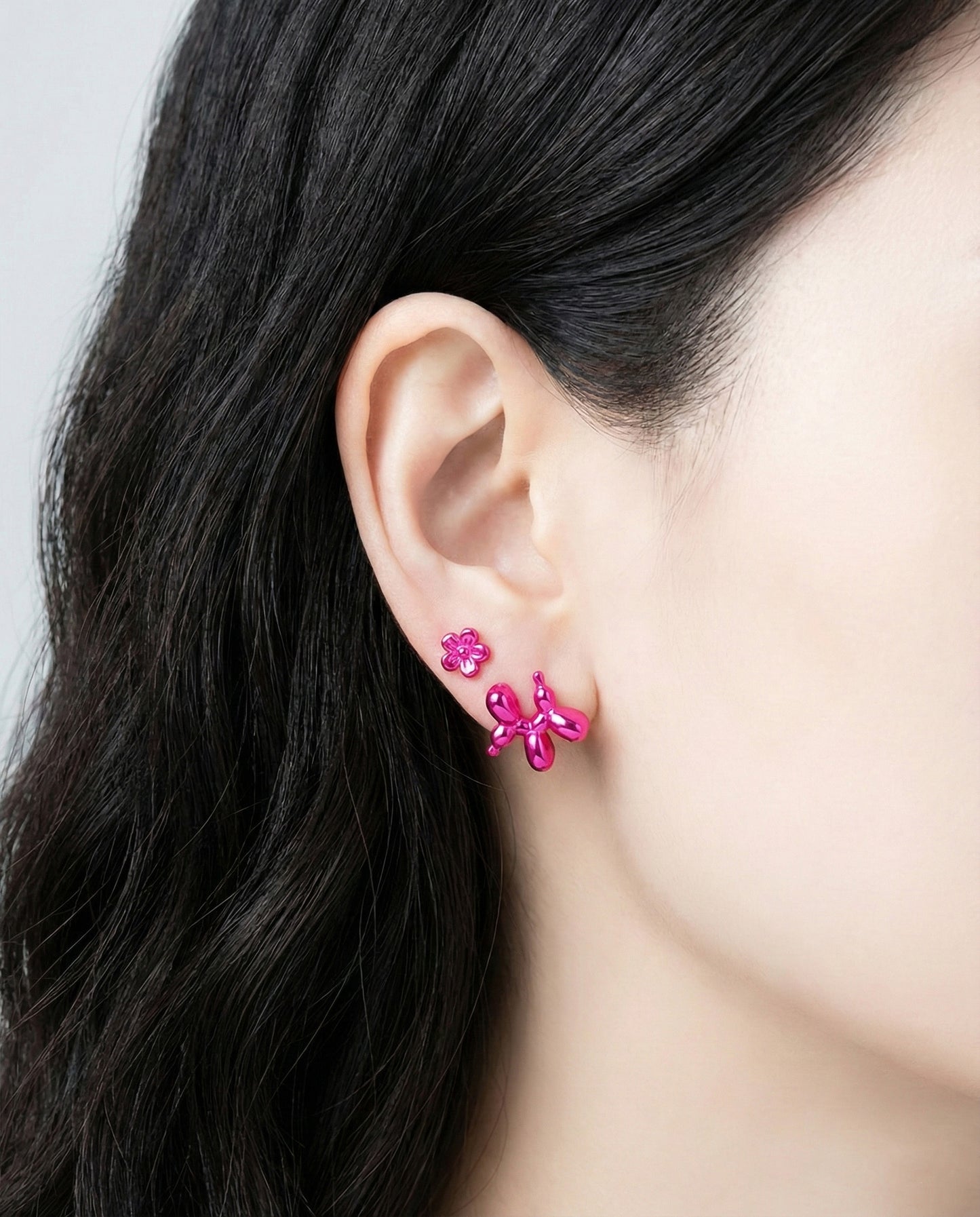 Model wearing fuchsia pink balloon dog earring solo showing Y2K pop art vibe