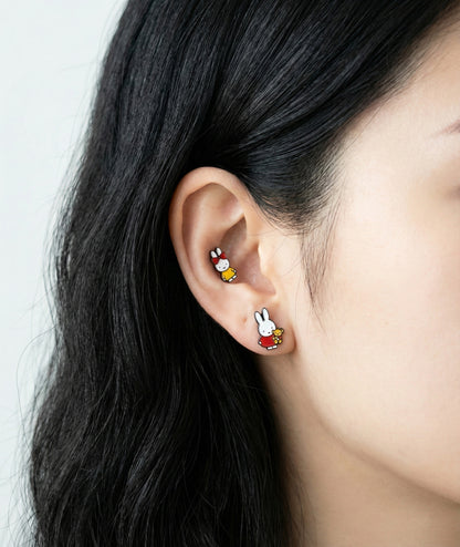Miffy character piercing layered on ear showing conch and lobe placement