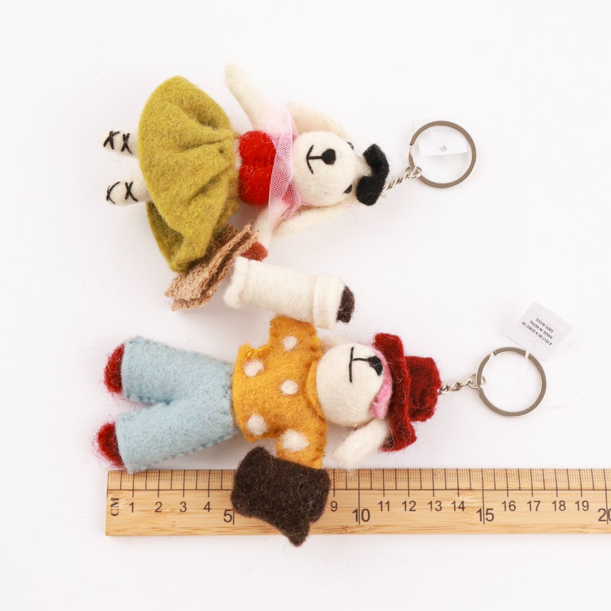 Size comparison of handmade wool felt dog keychains with ruler - 8-10cm artisan keyrings