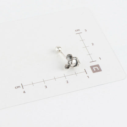 Size measurement of Mickey Mouse piercing with ruler showing dimensions
