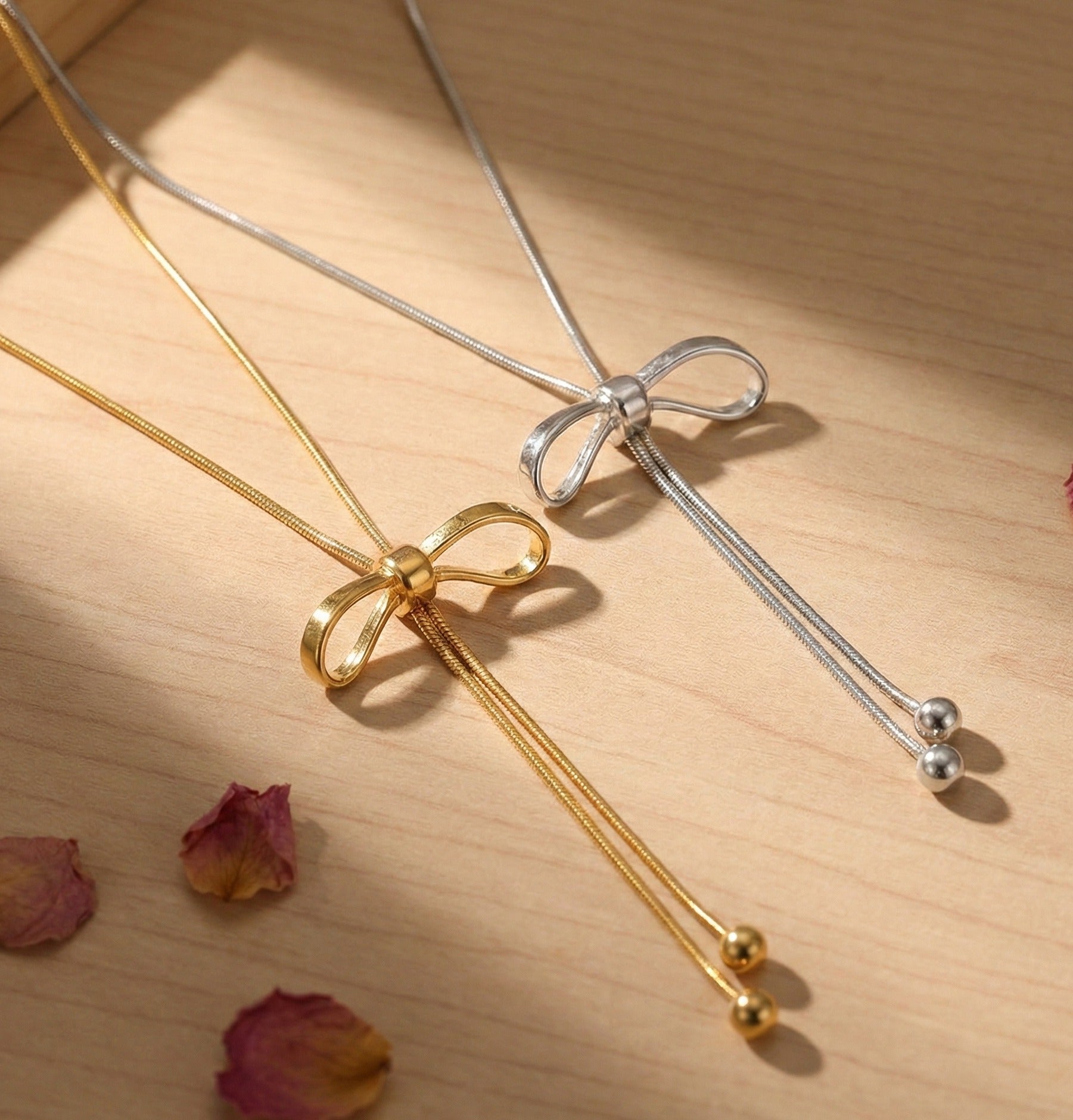Gold and silver bow lariat necklaces side by side - adjustable Y-drop necklace options