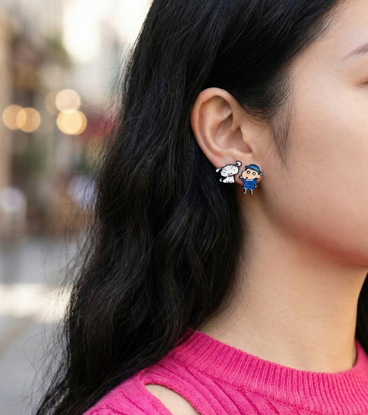 Outdoor natural light shot of model wearing school uniform Shin-chan and Shiro earrings with city bokeh background