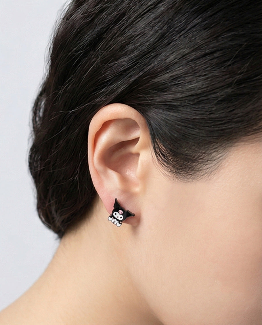 Close-up of a woman wearing a Kuromi-inspired black and white stud earring on her earlobe.