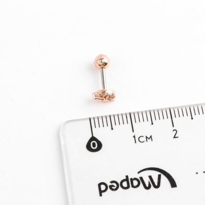 Size reference of tiny crescent moon star piercing next to ruler, approximately 5-6mm