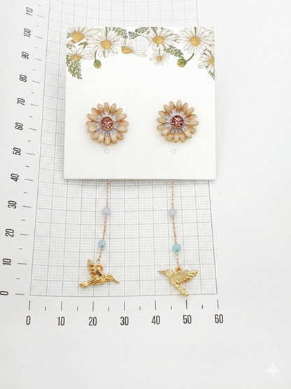 Measurement guide showing gold daisy earrings with ruler scale