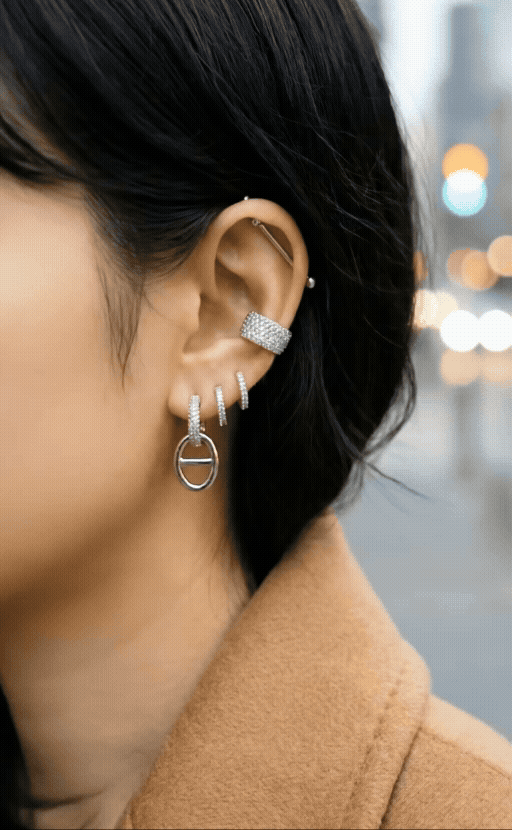 Ear stack featuring pavé huggie earrings layered with other jewelry