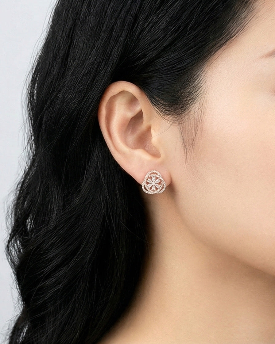 Woman wearing rose gold heart cubic zirconia earring on lobe showing elegant sparkle, 925 silver hypoallergenic posts, Korean romantic jewelry