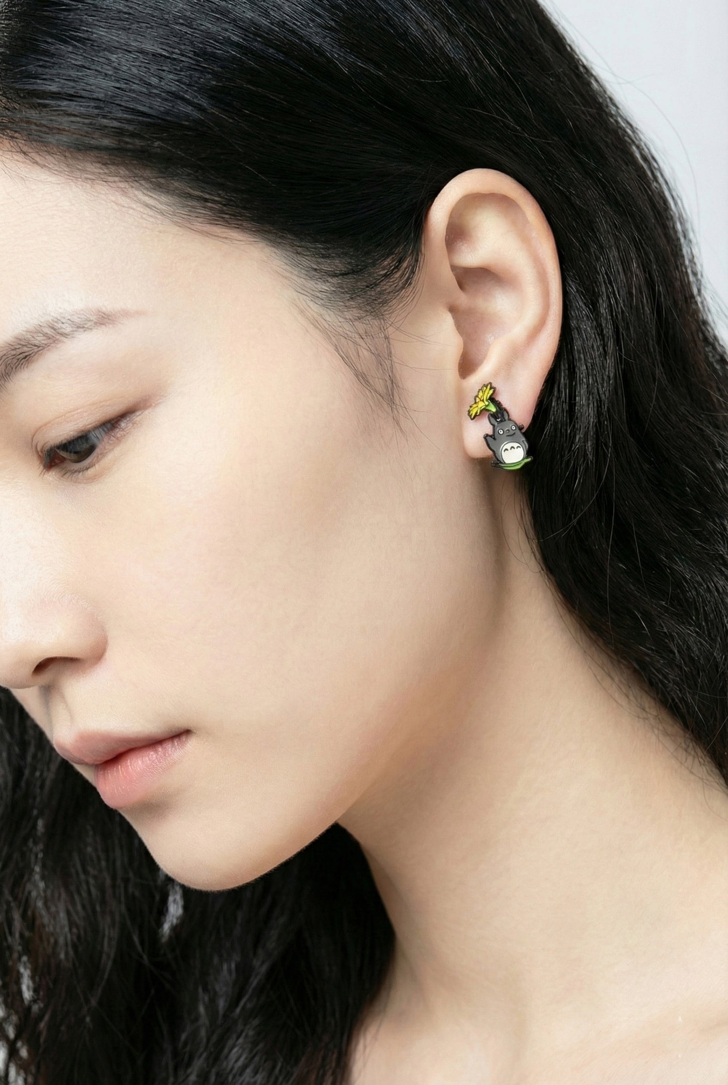 Close-up of forest spirit jacket earring worn on ear