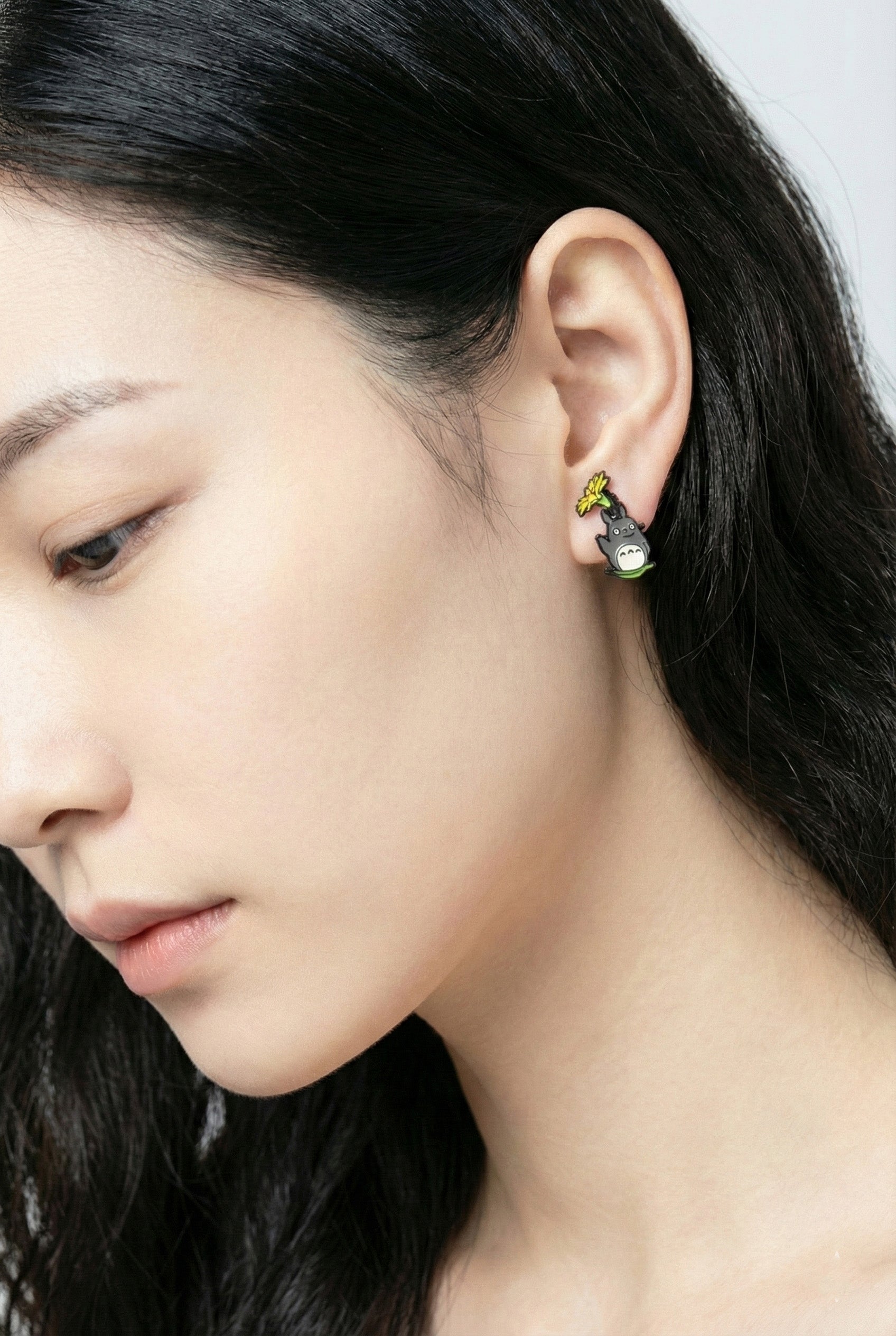 Close-up of forest spirit jacket earring worn on ear