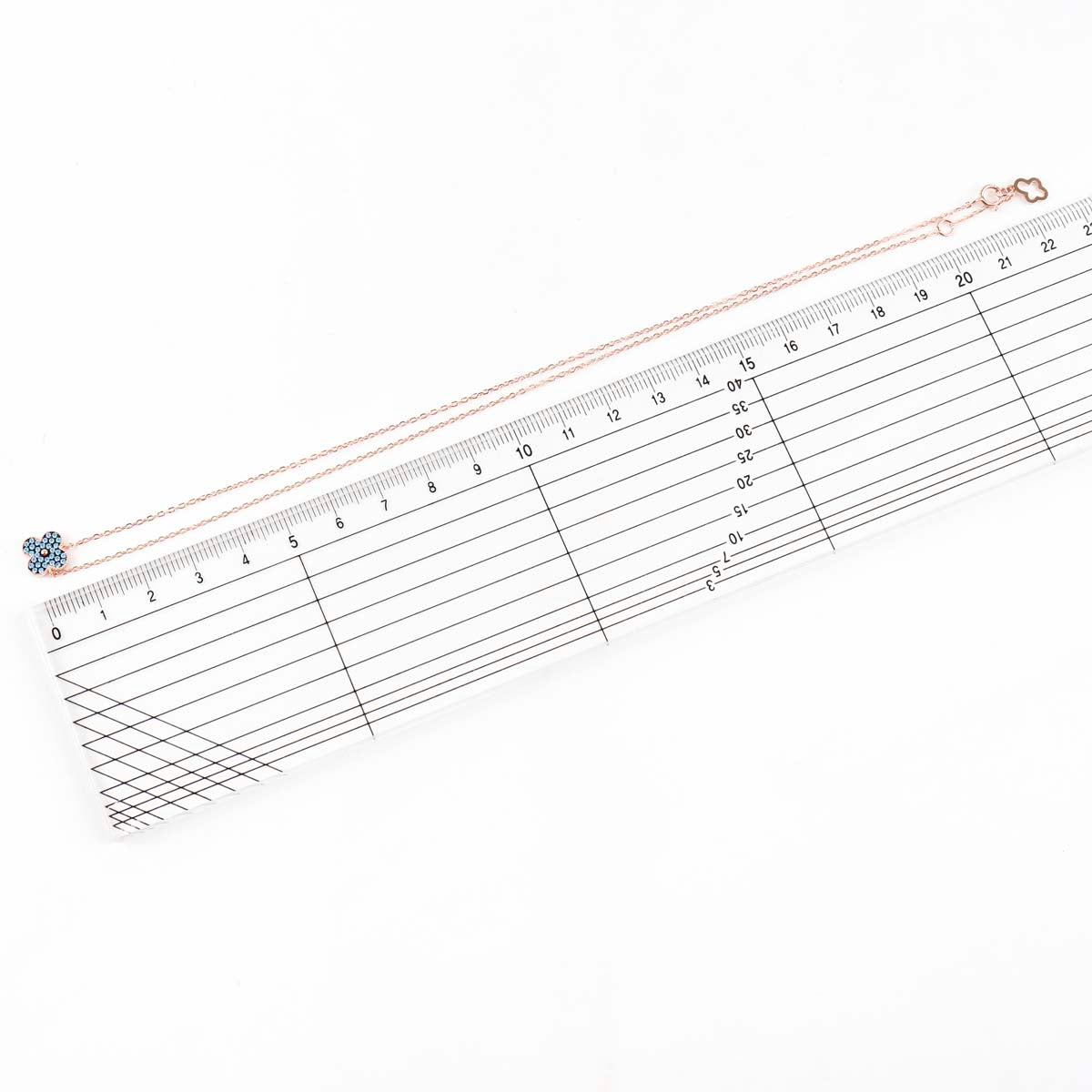 Size measurement of clover pendant and earrings, 8mm dimensions with ruler