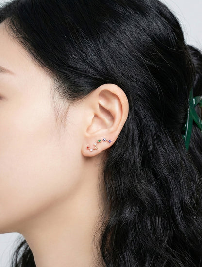 Model wearing rose gold rainbow constellation ear climber side profile view