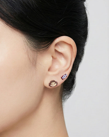 Woman wearing mismatched Peko Chan earrings showing puppy character and Poko stud on left ear for asymmetrical styling