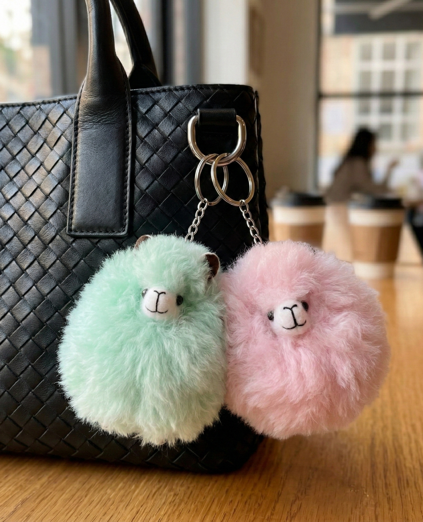 Make a stylish statement with our pastel alpaca fur keychains. The apple mint and baby pink fluffy charms perfectly complement any chic leather tote bag