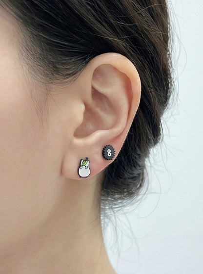 Side view of Totoro earring with flower umbrella on earlobe