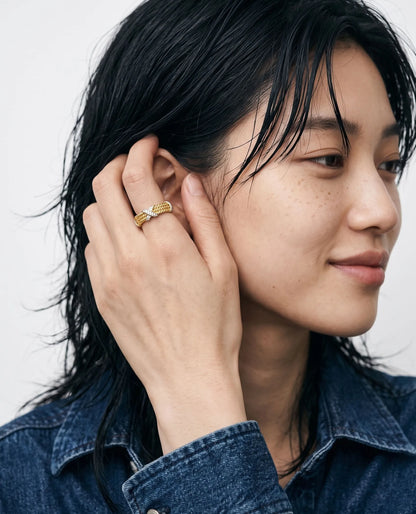 Clean girl aesthetic close-up portrait, two-tone cubic X ring styled with denim jacket.