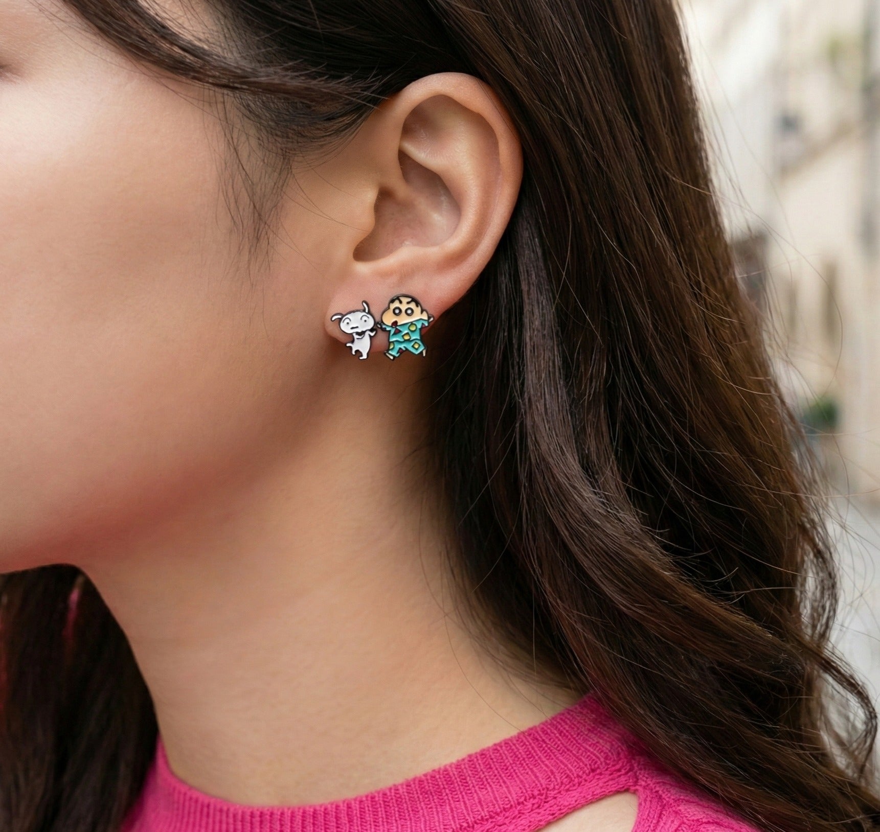Model wearing Shin-chan in pajamas enamel earring showing turquoise geometric pattern detail