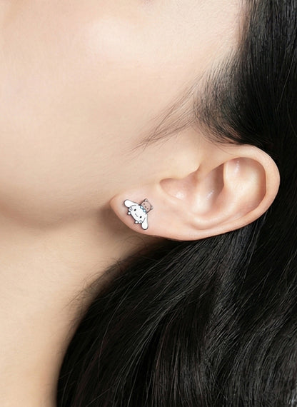 Close up of puppy with blue bow character earring on ear showing enamel detail