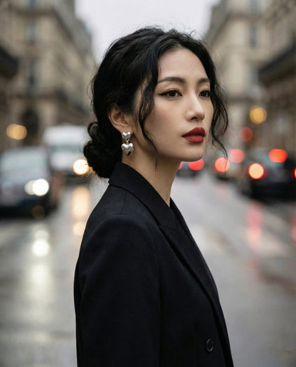 Model in black blazer wearing silver heart earrings - urban fashion editorial