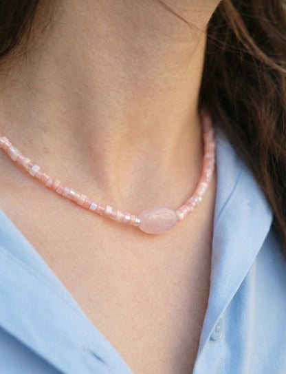 Close-up detail of rose quartz heishi bead choker showing natural gemstone texture
