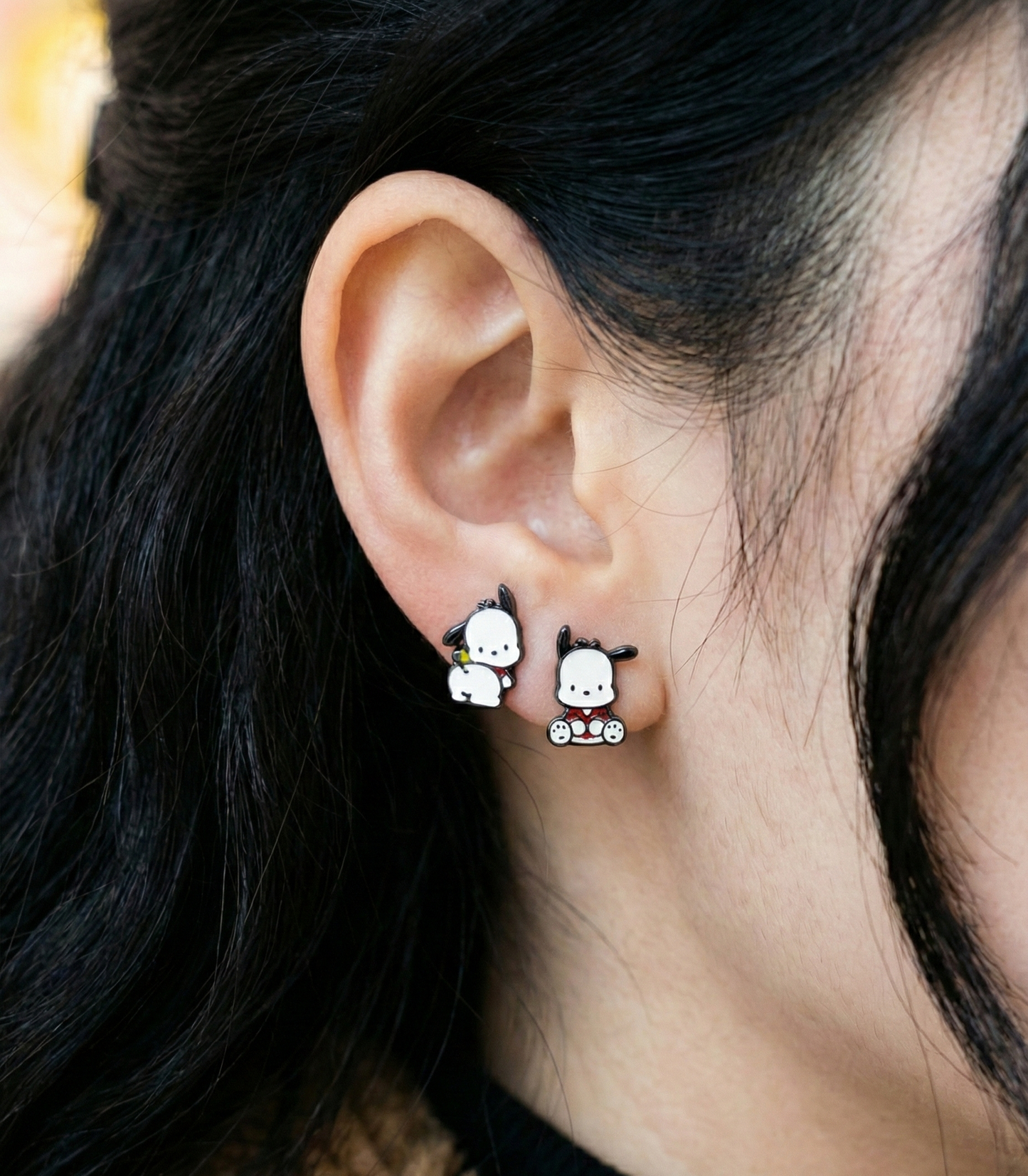  Close-up of Pochacco earrings worn on ear showing front face and back design asymmetry